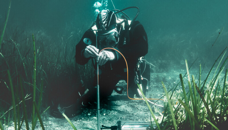 Diver working with sensors on the sea floor